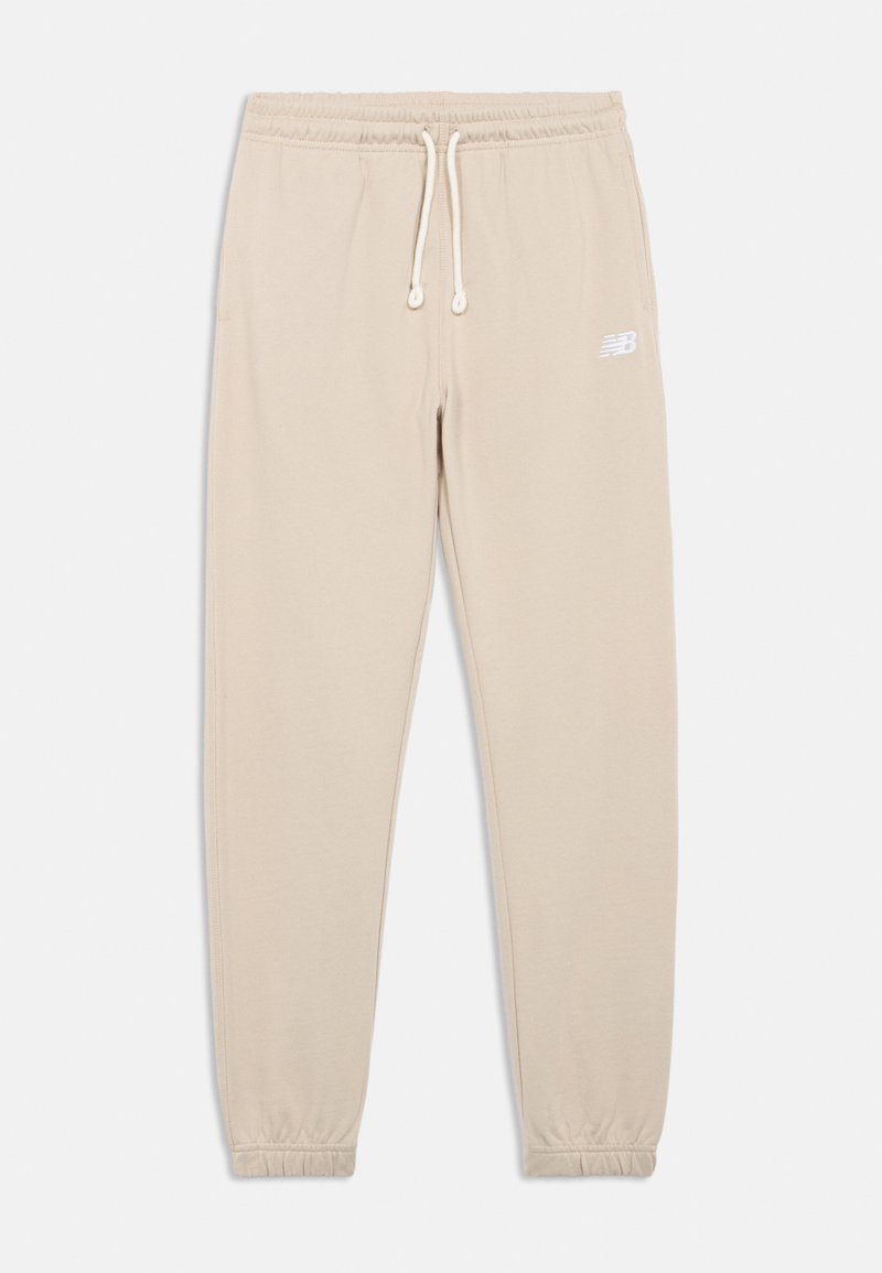 Beige sweatpants with an elastic waistband, adjustable drawstring, and elastic cuffs. Features a white logo on the left thigh. Soft texture.