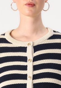 Navy and cream striped knitted cardigan with a round neckline and three golden buttons down the front. Textured fabric with horizontal lines.
