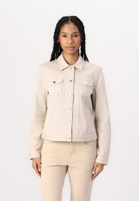 Beige denim jacket with a classic collar, silver buttons, and two front pockets. Fitted design with a slightly cropped length and smooth texture.