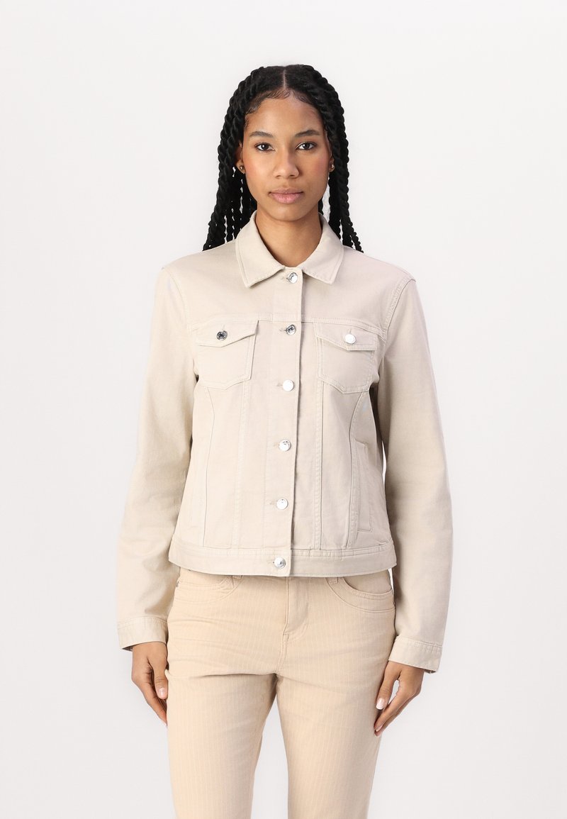 Beige denim jacket with a classic collar, silver buttons, and two front pockets. Fitted design with a slightly cropped length and smooth texture.