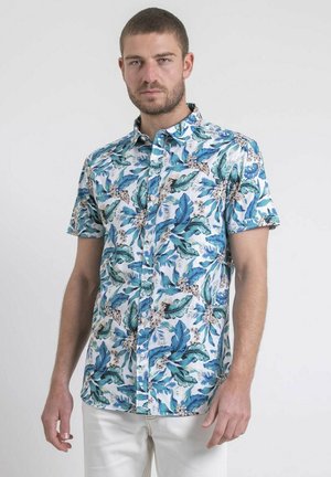 Chemise à manches courtes, boutonné, avec un motif de feuilles tropicales dans des nuances de bleu et de vert sur un fond blanc. Tissu en coton.