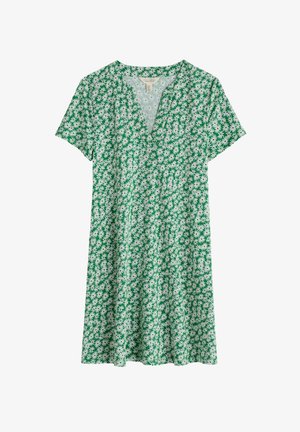 Žalia trumpa suknelė su V formos iškirpte, su baltu gėlių raštu ir laisvu kirpimu, kuris nusileidžia virš kelių. Pagaminta iš medvilnės.