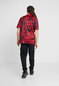 adidas Performance TAN - T-shirt con stampa - bordeaux
