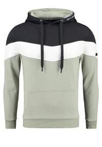 Felpa con cappuccio in verde oliva, nero e bianco con un design a chevron. Presenta una tasca frontale e coulisse. Tessuto dalla texture morbida.