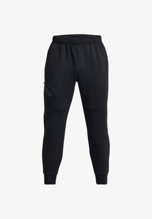 Black sweatpants made of soft fabric, featuring a drawstring waistband, tapered legs, and zippered side pockets. Textured accents outline the seams.