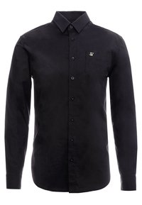 Musta pitkähihainen paita, joka on valmistettu sileästä kankaasta. Siinä on kaulus, nappilista ja rintatasku, jossa on pieni logokoriste.