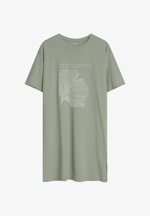 Jasnozielona bawełniana koszulka z krótkim rękawem, z białą grafiką liścia i napisem "ŚWIAT ROŚLIN NIERUCHOMA SYMBIOZA."