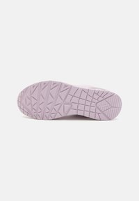 Purple athletic shoe sole with textured grip pattern, rounded toe, and durable rubber material, designed for traction and comfort.