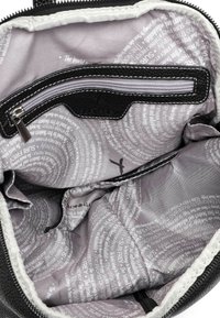 Black textured interior of a bag with a gray lining featuring spiral text patterns. Includes a zippered pocket and a smooth zip closure.