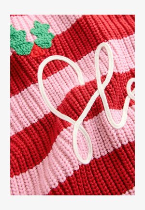 Gebreide stof met gedurfde rode en roze strepen, verfraaid met groene bladeren en een witte, gekrulde decoratieve element.