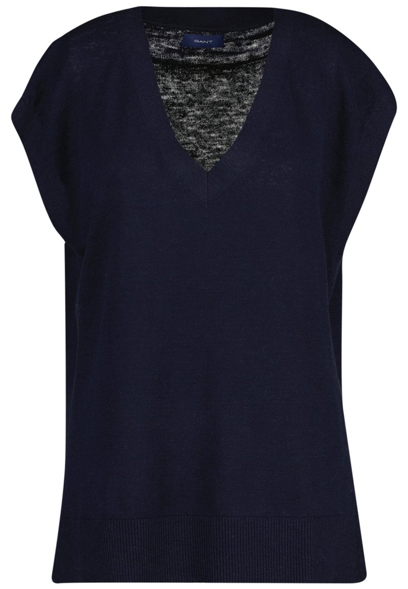Marineblå ærmeløs V-hals sweatervest med ribbet kant og en grå indvendig stof synlig ved halsudskæringen.