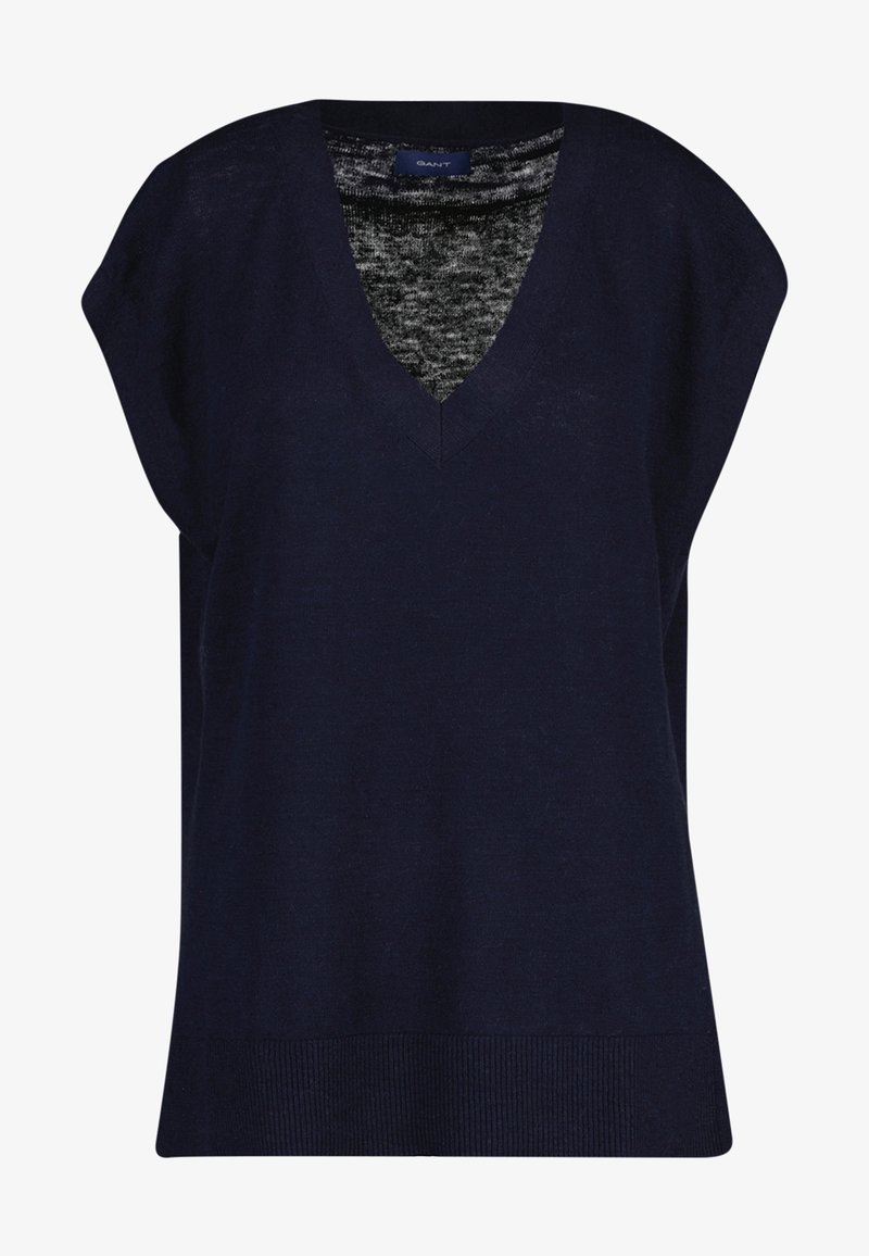 Marineblå ærmeløs V-hals sweatervest med ribbet kant og en grå indvendig stof synlig ved halsudskæringen.