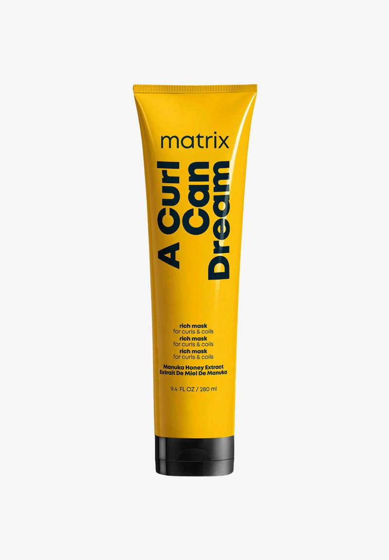 Gelbe Röhrenverpackung mit schwarzem Text. Das Etikett liest "A Curl Can Dream" und die Details besagen "reiche Maske für Locken & Coils." Enthält 280 ml.