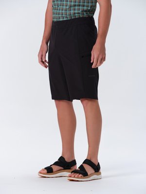 Schwarze Shorts mit einem seitlichen Reißverschlussfach, taillierte Passform, aus leichtem Material. Kombiniert mit schwarzen, verstellbaren Sandalen mit einer Korksohle.