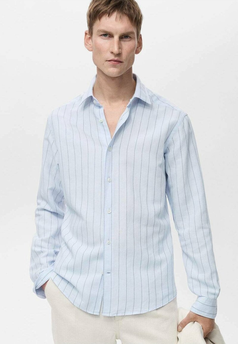 Lichtblauwe longsleeve shirt van stof met verticale witte strepen. Heeft een button-down kraag en een relaxed fit.