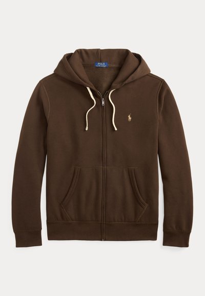 Brun zip-up hoodie i bomull. Har en framfickor, dragsko huva och broderad logotyp på bröstet. Krämfärgade dragsnören.