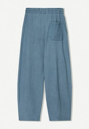 Light blue cotton pants with an elastic waistband, featuring a single back pocket and a relaxed, tapered leg design.