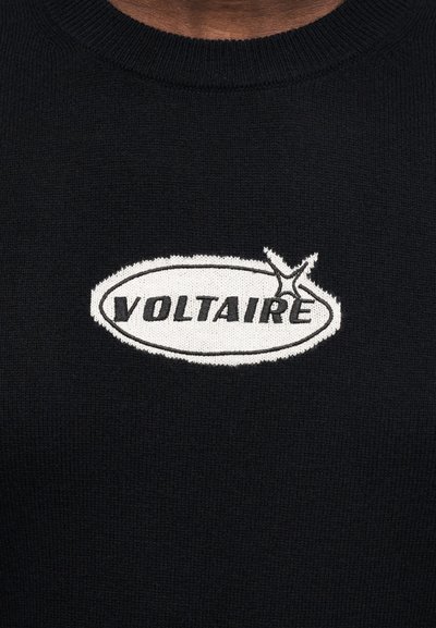 Black knitted sweater featuring a white oval logo with the text "VOLTAIRE" and a distinctive accent line above it. Soft texture.
