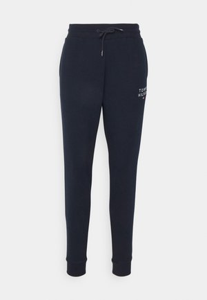 Pantalones de chándal azul marino con cintura elástica y cordón, piernas ajustadas, bolsillos laterales y detalle del logo bordado en el muslo izquierdo.