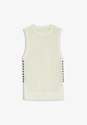 Valkoinen hihaton neulottu liivi, jossa mustat nyöritykset sivuilla sekä resorit helmassa ja pääntiessä.