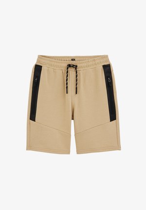 Beiget rento shortsit, joissa on joustava vyötärönauha, musta kiristysnauha ja mustat vetoketjulliset sivutaskut, suunniteltu mukavuutta ja käytännöllisyyttä varten.