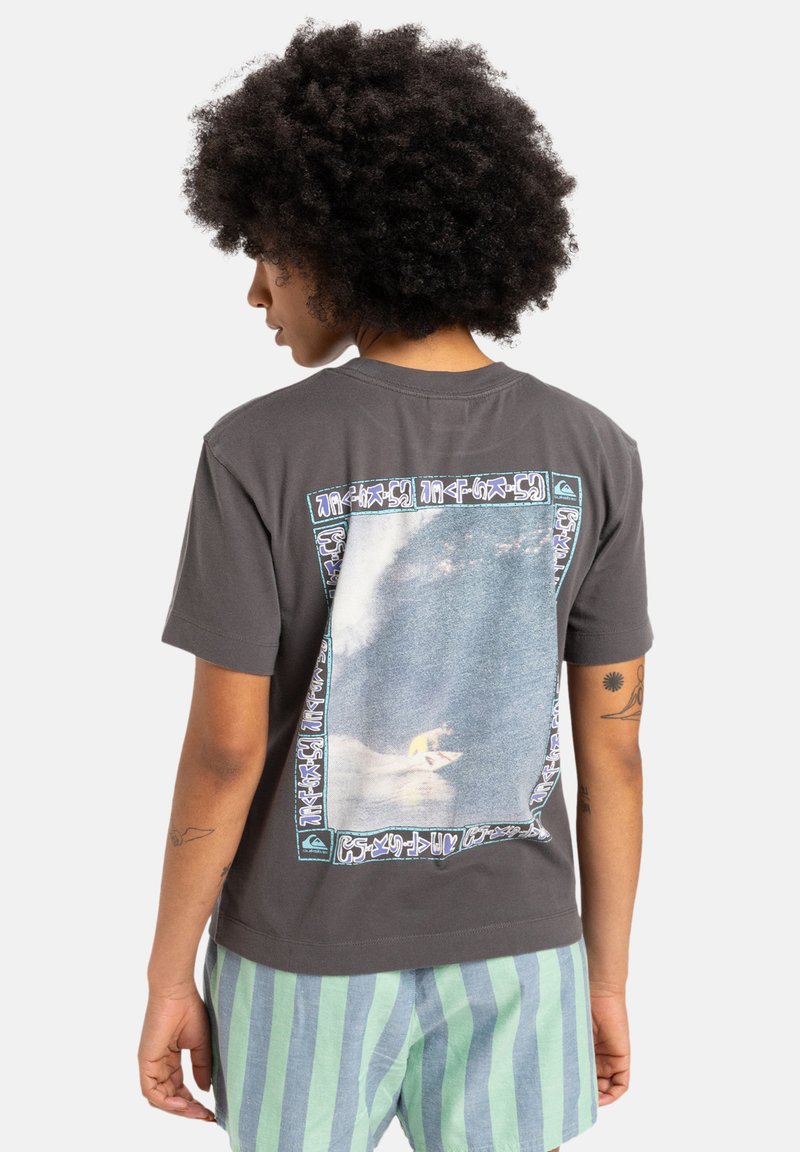 Gray cotton t-shirt featuring a large graphic of a surfer on the back, surrounded by a colorful patterned border. Short sleeves.