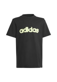 Musta puuvillapaita, jossa on suuri, rohkea, heijastava keltavihreä "adidas"-logo rinnassa. Klassinen pyöreä kaula-aukko.