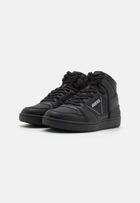Black high-top sneakers made of textured leather, featuring a perforated toe, padded collar, white logo, and flat rubber sole.