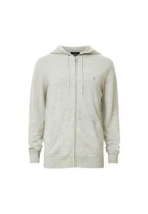 Ljusgrå zip-up hoodie med en minimalistisk design, kängurufickor och en liten logotyp på vänster bröst. Mjukt, texturerat tyg.