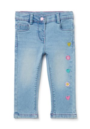 Jasnoniebieskie jeansy dla malucha z różowym przeszyciem oraz kolorowymi naszywkami w kształcie serc i kwiatów na jednej nogawce.