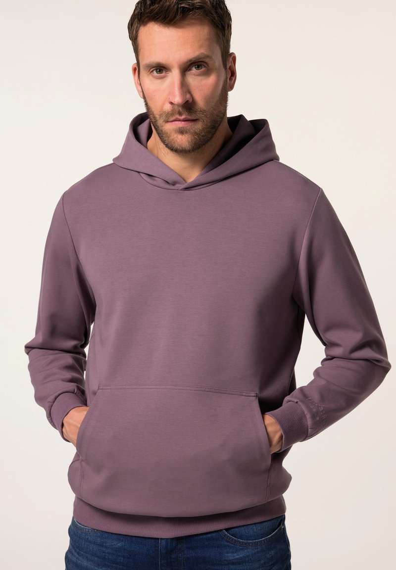 Felpa di cotone viola con tasca a marsupio, cappuccio con cordino e polsini a coste. Indossata con jeans blu, che mettono in mostra un design casual.