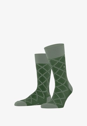 Grüne gemusterte Socken mit einem Diamantdesign, geripptem Bündchen und verstärkter Spitze sowie Ferse. Hergestellt aus weichem, strukturiertem Material.