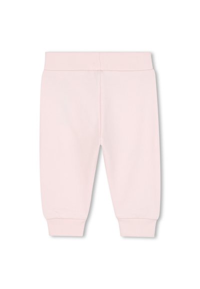 Pantaloni della tuta in cotone rosa con vita e polsini a costine; texture liscia, design affusolato e senza ulteriori motivi o dettagli.