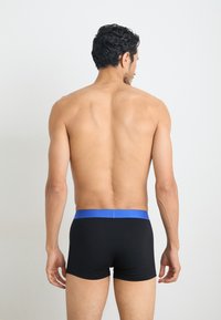 Black boxer briefs with a blue elastic waistband, featuring a smooth texture and a fitted design, viewed from the back.