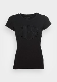 Camiseta de algodón negra con un diseño ajustado, cuello redondo y logo texturizado "GUESS" en un acabado negro contrastante en el pecho.