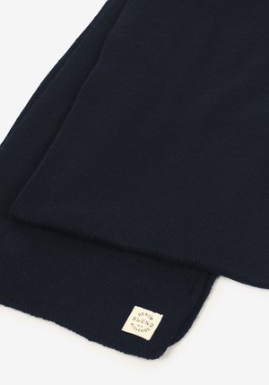 Écharpe en tricot bleu marine avec une texture douce, comportant une étiquette portant l'inscription « DENIM BLEND with ATTITUDE » dans une couleur contrastante.
