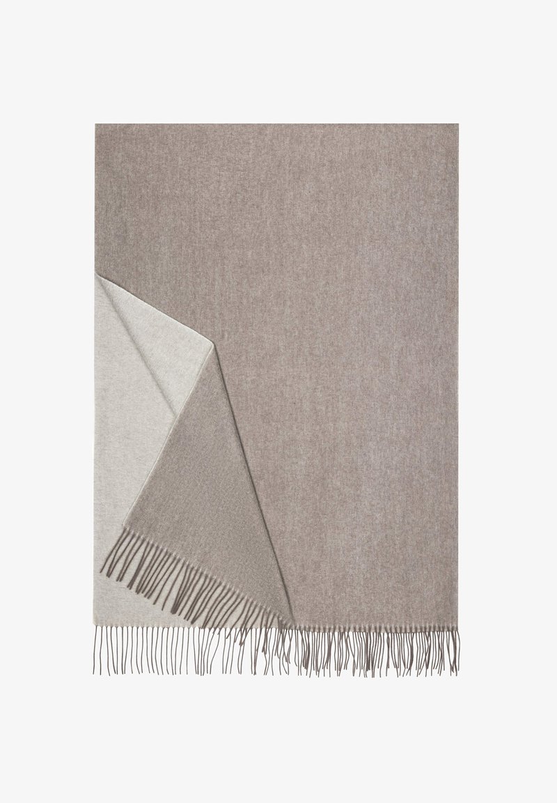 Woven blanket in light beige and taupe with fringed edges, showcasing a soft texture and a reversible design for versatile use.