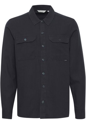 Black button-up shirt made of smooth fabric, featuring a pointed collar, two chest pockets, and buttoned cuffs. Simple design with subtle texture.