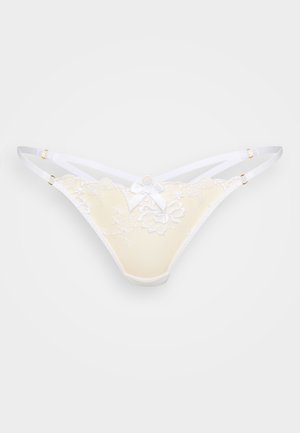 String jaune avec bordure en dentelle et bretelles blanches, ornée d'une broderie florale, d'un nœud décoratif et de ferrures dorées. Texture lisse dans l'ensemble.