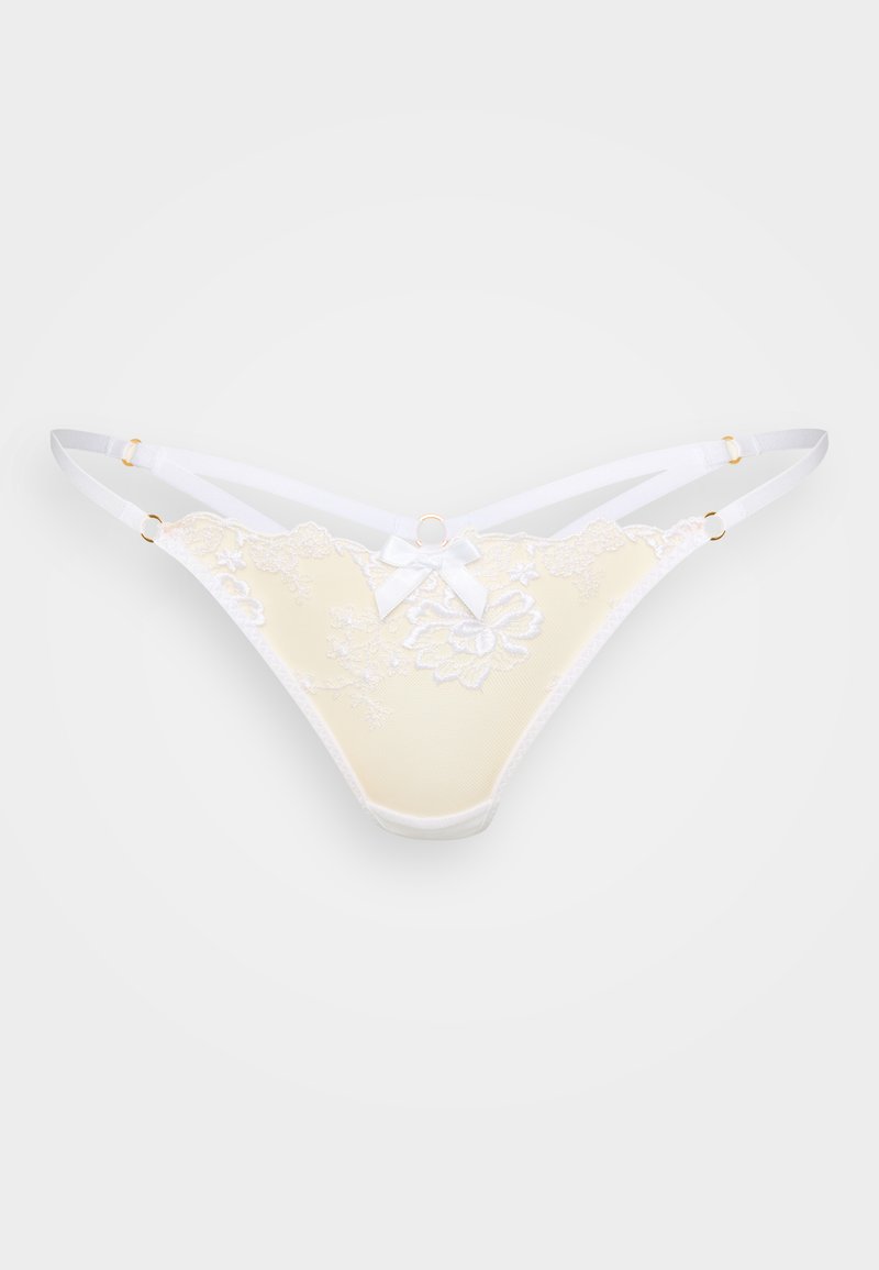 Csipkével szegélyezett sárga tangapant, fehér pántokkal, virágmotívumos hímzéssel, masni díszítéssel és arany tónusú szerelékkel. Általánosan sima tapintású.