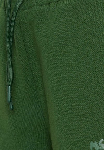 Groene joggingsbroek van zacht katoen, met een trekkoord in de taille en geribbelde textuur. Inclusief zijzakken voor praktische doeleinden.