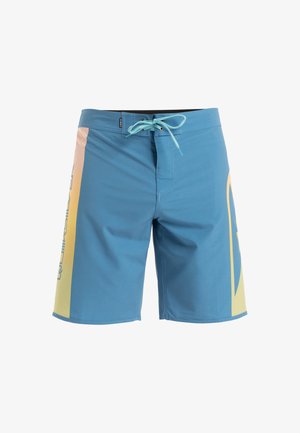 Blue swim shorts with a yellow gradient side panel, featuring a drawstring closure and a printed logo along the side. Smooth texture.