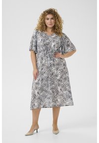 Robes florales mi-longues en tissu léger. Comprend des manches courtes, une taille élastique et un motif de feuilles monochrome en noir et blanc.