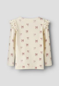 Cream long-sleeve top with ruffled shoulder accents, featuring a repeated pattern of light pink bows. Soft ribbed texture throughout.