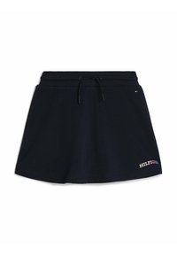 Falda de algodón azul marino con cintura elástica y cordón ajustable. Presenta un colorido logo bordado de "HILFIGER" en la parte inferior.