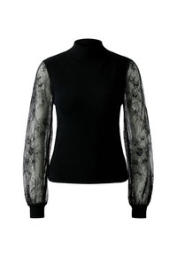 Haut en tricot noir ajusté avec un col montant et des manches longues en dentelle transparente ornées de motifs floraux et de poignets côtelés.