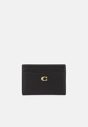 Black leather cardholder featuring a textured surface, gold hardware logo, and multiple card slots. Simple, rectangular design.