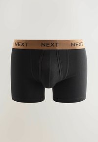 Svarta boxertrosor med en brun elastisk midja med "NEXT" tryckt i svart. Mjukt tyg med en åtsittande passform och korta ben.
