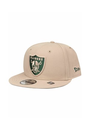 Beige baseball cap with flat brim, featuring a green and black embroidered Raiders logo on the front and a New Era logo on the side.