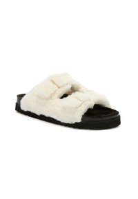 Faux fur slide sandal in cream color with a black sole. Features two wide straps and a soft, textured upper for comfort.